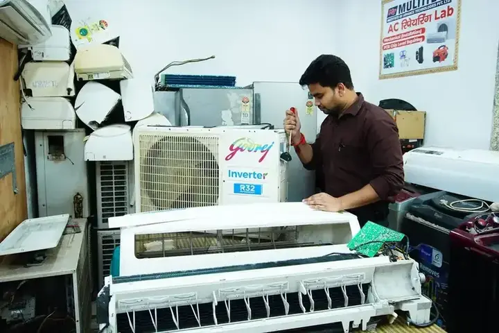 Technician repairing an air conditioner in the workshop